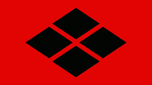 a red background with four black squares that look like diamonds