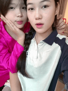 two girls are posing for a picture and one has a shirt that says adidas on it