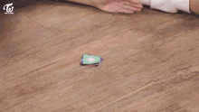 a group of girls are playing a game on the floor and one of them has a sweatshirt on that says ' a '