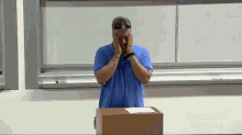 a man covering his face in front of a podium that says stanford university on it