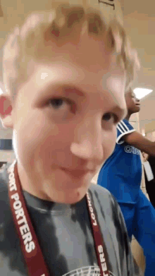a young boy wearing a lanyard that says port porters