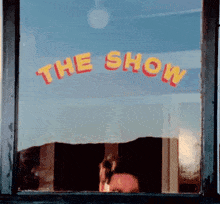 a window with the words the show written on it
