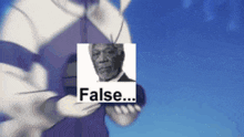 a man is holding a picture of a man with the word false above him