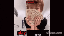 a man is holding a fan of money in front of his face .