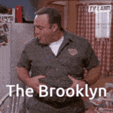 a man is holding his stomach with the words the brooklyn written on it
