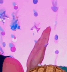 a close up of a person 's feet against a pink background with a pineapple in the foreground .
