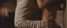 a man and a woman are hugging each other while laying on a bed .