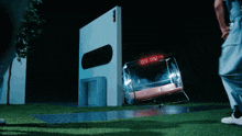 a person standing in front of a sign that says ' emergency exit '