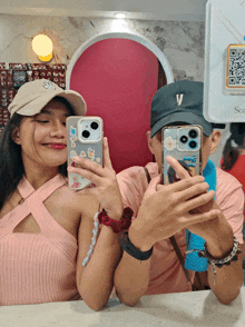 a man and a woman are taking a picture of themselves with their cell phones