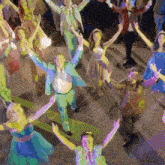 a group of people are dancing with their hands in the air