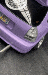 a purple car with a new york license plate that says bb239