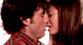 a man and a woman are kissing with their tongues out