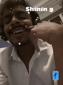 a man wearing headphones and a white shirt has the word shining written on his face