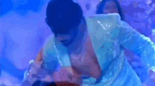 a man and a woman are kissing in front of a blue background .