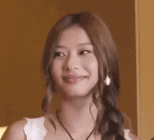 a woman with her eyes closed is wearing a braided ponytail .