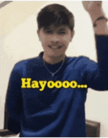 a man wearing a blue shirt that says hayooo on it