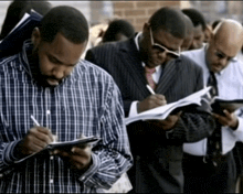 a man in a plaid shirt is writing on a clipboard