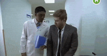 a man in a suit and tie talking to a doctor