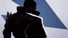 a silhouette of a person standing in front of a blue and white triangle