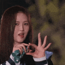 a woman with her tongue out is holding a piece of paper that says ' strawberry ' on it