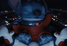 a blue and red cartoon character with the number 11 on his chest