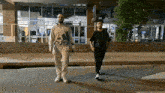 a man wearing an adidas sweatshirt walks down the street