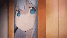 a girl with blue eyes is peeking out from behind a door