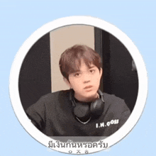 a young man wearing headphones and a black shirt that says i.m. does