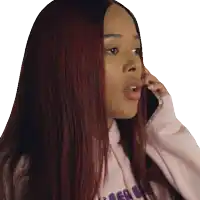 a woman with long red hair is talking on her phone