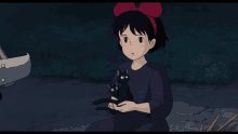 a girl in a purple dress is holding a black cat on her shoulder
