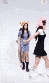 a group of girls are standing next to each other wearing monkey hats and socks .