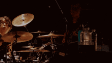 a drummer playing a meinl cymbal in a dark room