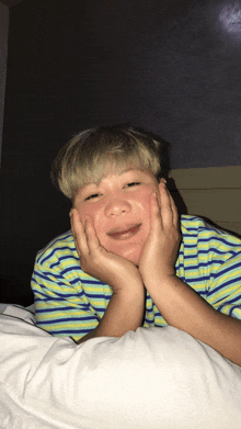 a person laying on a bed with their face in their hands