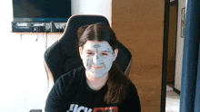 a girl with a mask on her face is wearing a shirt that says sick on it