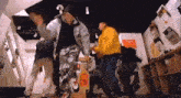 a group of people are dancing in a room with a sign on the wall that says ' a ' on it .