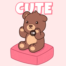 a teddy bear is sitting on a pink pillow with the word cute behind it