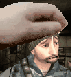 a man with a beard and a hat is being held by a person 's hand .