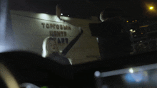 a woman is dancing in front of a building that says торговый центр арт