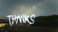 the word thanks is spray painted on a dark sky