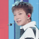 a close up of a person wearing a microphone and earbuds