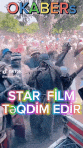 a group of people are dancing in front of a sign that says star film