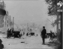 a black and white photo of soldiers in a war scene taken by the pathe