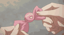 a person is holding a piece of pink paper that says tbs