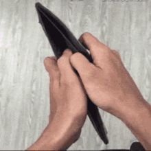 a person is holding an empty wallet with their hands