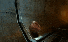 a computer generated image of a person 's head hanging from a wall