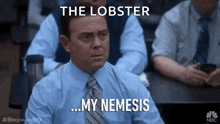 a man in a suit and tie is sitting in a classroom with a caption that says the lobster my nemesis