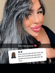 a woman with long black hair is smiling with a snapchat message in front of her that says oui c'est promis