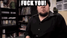 a man with a bird on his shoulder is making a funny face and says fuck you .