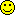a pixel art of a yellow smiley face with black squares on it .
