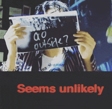 a person is holding a sign that says go outside
